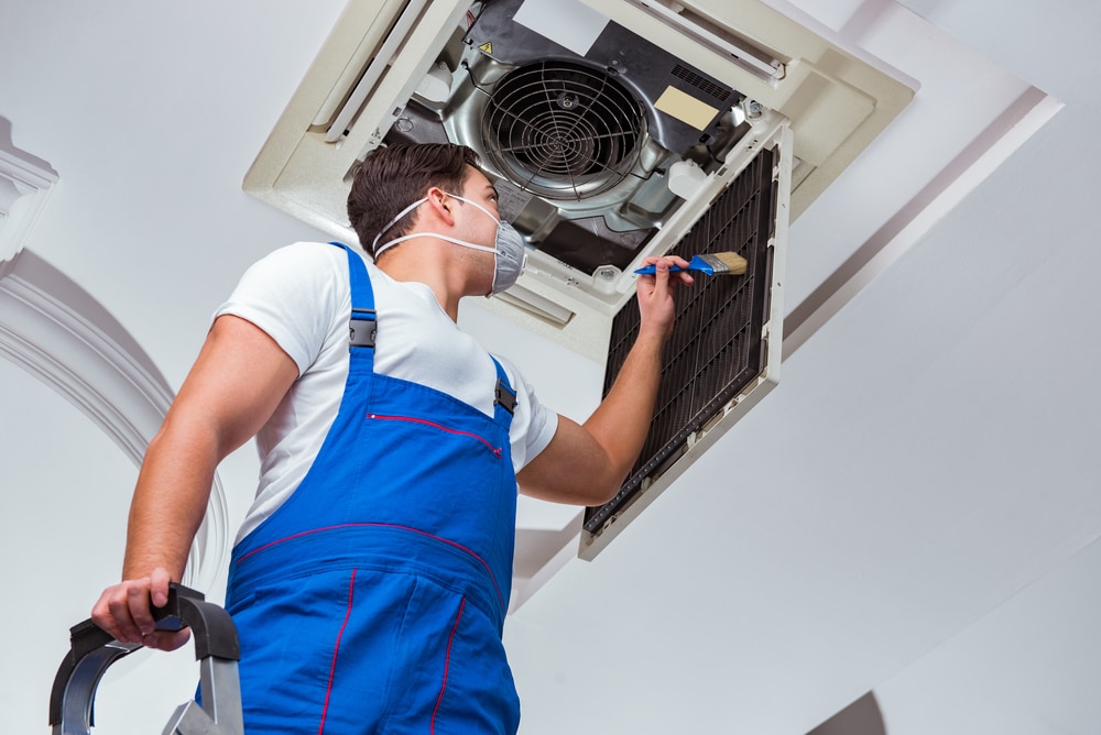 HVAC Technician Repairs Air Conditioner