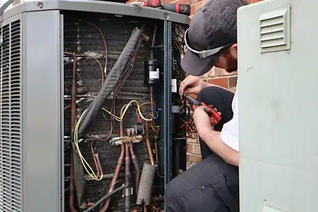 Technician working on an AC heat pump replacement